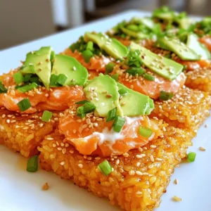 - 2 cups cooked sushi rice - 1 tablespoon rice vinegar - 1 teaspoon sugar - Salt, to taste - 1 pound fresh skinless salmon - 2 tablespoons sriracha - 1 tablespoon mayonnaise (preferably Kewpie for creaminess) - 1 ripe avocado, thinly sliced - 1/4 cup green onions, finely chopped - 1 teaspoon sesame oil - 1 tablespoon panko breadcrumbs - Seaweed sheets, cut into strips for garnish (optional) To make crispy rice with spicy salmon, we need fresh ingredients. Sushi rice is key for texture. Rice vinegar adds a nice tang to the rice. Sugar balances the flavors, while salt brings it all together. Salmon is the star of this dish. Use fresh, skinless salmon for the best taste. Sriracha gives it that spicy kick. Mixing sriracha with mayonnaise makes a creamy sauce. You can add avocado for creaminess and green onions for freshness. Sesame oil adds a nutty flavor, and panko breadcrumbs give crunch. Seaweed strips can be a fun garnish. You can find the full recipe in the next section. This dish is both tasty and fun to make! To start, you need to mix the sushi rice. In a medium bowl, gently combine 2 cups of cooked sushi rice with 1 tablespoon of rice vinegar, 1 teaspoon of sugar, and a pinch of salt. Stir this until all ingredients mix well. Allow the rice to cool a bit. After cooling, take small portions of the rice and shape them into patties. Aim for rectangular shapes about 1-inch thick. Next, it’s time to cook the rice patties. Heat a non-stick skillet over medium heat. Add a light drizzle of sesame oil. Wait until the oil shimmers. Carefully place the rice patties in the skillet. Cook each side for about 3 to 4 minutes. You want them golden brown and crispy. When they finish cooking, take them out and let them drain on a paper towel. This helps absorb extra oil. Now, let’s make the spicy salmon. In a mixing bowl, combine 2 tablespoons of sriracha with 1 tablespoon of mayonnaise. Blend these until smooth. Then, cut 1 pound of fresh skinless salmon into bite-sized cubes. Gently fold the salmon into the spicy mayo. Make sure each piece gets coated well. This adds a nice kick to your dish. For the full recipe, check out the instructions above. To make crispy rice, time and heat are key. Cook your rice patties for about 3-4 minutes on each side. This gives them a golden crust. Make sure your skillet is hot. A non-stick skillet works best and needs a light drizzle of sesame oil. This oil adds flavor and helps the rice crisp. After cooking, let them rest on paper towels. This removes excess oil and keeps them crispy. For sushi rice, mix in rice vinegar, sugar, and a pinch of salt. This adds a nice tang and sweetness. You can also try adding some sesame seeds or a splash of soy sauce to the rice for more depth. For toppings, sliced avocado adds creaminess. Chopped green onions give a fresh taste. Panko breadcrumbs on top add a crunchy finish. When serving, arrange your crispy rice patties on a nice platter. You want them to look appealing. Top each patty with the spicy salmon mix. A slice of avocado on top is both pretty and tasty. Sprinkle green onions for color and flavor. For a fun touch, add edible flowers or sesame seeds as a garnish. You can serve with chopsticks to make it more authentic. Enjoy your flavorful delight! {{image_4}} If you want to mix things up, consider different proteins. You can easily swap salmon for tuna or crab. Both options add their own unique flavor and texture. For a vegan choice, try tofu or tempeh. These plant-based proteins work well with spicy sauces. You can even create plant-based sauces using vegan mayo and sriracha. You can make this dish spicy or mild. If you prefer a kick, add more sriracha or a dash of chili oil. For a milder version, use a light hand with the spice. You can also explore international flavors. Adding soy sauce or wasabi gives a Japanese twist. For a Mexican flair, try pico de gallo or a lime drizzle. Think about how you want to serve this dish. You can cut the crispy rice into smaller pieces for bite-sized appetizers. They’re perfect for parties! Or, you can keep them larger for a main course. For a party platter, arrange them on a big tray. Add colorful garnishes like sliced radishes or edible flowers for an eye-catching display. Try these ideas to create your own version of crispy rice with spicy salmon. For the full recipe, check out the earlier section! To keep your crispy rice with spicy salmon fresh, store it properly. First, let the dish cool down to room temperature. Then, place any leftovers in an airtight container. It’s best to eat them within two days. - Refrigeration guidelines: Store the dish in the fridge. It stays good for about 48 hours. Make sure the container is sealed tight to prevent air from getting in. - Freezing options: You can freeze the rice patties, but the salmon is best fresh. To freeze, wrap the rice patties in plastic wrap and place them in a freezer bag. Use them within one month for the best taste. When reheating, you want to keep that crispy texture. Here are some tips: - Techniques to retain crispness: Use a pan to reheat the rice patties over medium heat. Add a small amount of oil to help regain crispness. Cook each side for about two minutes until they are warm and crispy again. - Avoiding soggy rice: Avoid using the microwave for the rice patties. It makes them soggy. If you must, cover them with a paper towel to absorb moisture, but pan frying is always best. Enjoy your delicious leftovers! To make Crispy Rice with Spicy Salmon, follow these steps: 1. Prepare the sushi rice: Mix cooked sushi rice with rice vinegar, sugar, and salt. 2. Shape the rice: Form this mixture into rectangular patties. 3. Pan-fry the rice: Cook the patties in a skillet with sesame oil until golden brown. 4. Make the spicy salmon: Combine sriracha and mayonnaise, then mix with diced salmon. 5. Assemble the dish: Place the salmon atop the crispy rice patties. 6. Garnish: Add avocado slices and green onions for color. You can find the full recipe in the earlier section. Yes, you can prepare elements ahead of time. Make the sushi rice and form the patties. Store them in the fridge for up to one day. You can also make the spicy salmon mix in advance. Just keep it chilled until you are ready to serve. This dish pairs well with: - Edamame: Lightly salted and steamed. - Seaweed salad: Adds a fresh crunch. - Miso soup: Complements the flavors perfectly. - Pickled vegetables: Provides tang and contrast. To pick fresh salmon, check these points: - Color: Look for bright pink or orange hues. - Texture: The flesh should feel firm and not mushy. - Smell: Fresh salmon has a clean scent, not fishy. - Eyes: If buying whole fish, clear eyes show freshness. Yes, this recipe works well for meal prep. Store the crispy rice and spicy salmon separately to keep the rice crunchy. You can refrigerate them for up to three days. When ready to eat, reheat the rice in a skillet to regain crispiness. This recipe for crispy rice with spicy salmon offers a fun and tasty meal. You learned how to prepare the rice, fry it for crunch, and mix it with salmon. With tips on flavors and storage, you can enjoy this dish for days. Feel free to try variations based on your taste. Cooking can be creative and rewarding. Enjoy every bite and share your masterpiece with friends. Happy cooking!