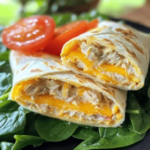The tuna melt wrap is a tasty meal option. It combines creamy tuna with fresh veggies and gooey cheese. This recipe is quick and easy, perfect for lunch or a light dinner. You can find the full recipe below for step-by-step guidance. - 1 can of tuna in water, drained - 2 tablespoons creamy mayonnaise - 1 tablespoon tangy Dijon mustard - 1/4 cup finely chopped red onion - 1/4 cup crisp diced celery - 1/2 cup shredded sharp cheddar cheese - 4 large flour tortillas - 1 cup fresh baby spinach leaves - Salt and freshly cracked black pepper to taste - Olive oil for grilling These ingredients come together to make a filling and satisfying wrap. The tuna adds protein, while the cheese brings richness. The veggies add crunch and freshness. You can make this wrap your own by adding extra ingredients. Here are some fun ideas: - Sliced avocado for creaminess - Chopped pickles for a tangy crunch - Sliced jalapeños for heat - Fresh herbs like dill or parsley for flavor Feel free to mix and match these add-ins. They can elevate your wrap and make it even more enjoyable! Start by draining the can of tuna. You want it dry to avoid a soggy wrap. In a medium bowl, mix the tuna with creamy mayonnaise and tangy Dijon mustard. Add chopped red onion and diced celery for crunch. Stir well to coat the tuna. Next, fold in the shredded sharp cheddar cheese. It should blend evenly throughout the mixture. Add salt and black pepper to taste. Adjust as you like. This mixture is the heart of your wrap, so make it tasty! Lay out the large flour tortillas on a clean surface. In the middle of each tortilla, place a handful of fresh baby spinach leaves. This adds a fresh touch and helps the wrap stay vibrant. Spoon a good amount of the tuna mixture onto the spinach. Spread it out a bit for even coverage. Now, roll each tortilla tightly. Tuck in the sides as you go. This keeps all the yummy filling secure. Heat a skillet over medium heat and add a drizzle of olive oil. Once the oil is hot, lay the wraps seam-side down in the skillet. Grill for about 3-4 minutes on each side. You want them golden brown and crispy, with the cheese melted inside. After grilling, remove the wraps and let them cool for a minute. Slice them in half diagonally for a nice look. If you like, garnish with sliced ripe tomatoes. Now, your tuna melt wraps are ready to enjoy! Find the full recipe [here](#). When you pick tuna, look for high-quality options. Canned tuna should have a good color. Choose light tuna for a milder taste. If you want something richer, go for chunk white tuna. Always check the label for sustainability. Brands that use responsible fishing practices are the best choice. Your tuna melt will taste better and help the planet too. Grilling your wraps right makes all the difference. Use a non-stick skillet or grill pan. Heat it over medium heat and add olive oil. Make sure the oil is hot before adding the wraps. This helps them get golden brown and crispy. Grill each side for about 3-4 minutes. Keep an eye on them, so they don’t burn. You want that cheesy goodness to melt and ooze out! Prep your tuna mixture ahead of time for quick meals. You can store it in the fridge for up to two days. Just keep it in an airtight container. When you’re ready to eat, grab your tortillas and spinach. Assemble your wraps in minutes. This saves you time on busy days. You’ll have a tasty meal ready to go without the fuss. For the full recipe, refer back to the initial section. {{image_4}} You can make a tasty vegetarian version. Substitute the tuna with mashed chickpeas. Mash them well and mix with mayonnaise and mustard. Add in red onion, celery, and cheese. You can also add diced bell peppers for a crunchy twist. This keeps the same great wrap feel while being meat-free. If you like heat, try this spicy twist. Add chopped jalapeños or a splash of hot sauce to the tuna mix. You can even stir in some sriracha for extra kick. Consider using pepper jack cheese. This adds a creamy, spicy flavor that will excite your taste buds. For a gluten-free option, swap flour tortillas for gluten-free wraps. Many good brands offer tasty choices. Always check the label for hidden gluten. You can also use lettuce leaves for a low-carb wrap option. This keeps your meal light and fresh while packing in the flavor. To keep your tuna melt wraps fresh, store them in the fridge. Place any leftovers in an airtight container. This helps to keep the flavors intact. The wraps will stay good for about three days. If you notice any off smells or changes in texture, it's best to toss them. Always check your food before eating. If you want to save some wraps for later, you can freeze them. Wrap each tuna melt in plastic wrap, then put them in a freezer bag. This prevents freezer burn and keeps them tasty. They will last in the freezer for about a month. When ready, thaw them in the fridge overnight before reheating. Reheating tuna melts can be easy. You can use a skillet or an oven. If using a skillet, heat it on medium. Place the wrap in the pan for about 3-4 minutes per side. This helps keep the outside crispy. If you prefer the oven, preheat it to 350°F (175°C). Bake the wraps for about 10-15 minutes, until warm. Enjoy your tasty tuna melt again! For the full recipe, refer to the earlier sections. You can use Greek yogurt instead of mayonnaise. It gives a creamy texture and adds protein. Another good option is avocado. It adds rich flavor and healthy fats. You can also try hummus for a unique twist. This makes your tuna melt wrap light and fresh. Yes, you can add many vegetables. Chopped bell peppers add crunch and sweetness. Grated carrots can give more color and flavor. You can also use cucumber for a crisp bite. Just make sure to chop them small so they mix well with the tuna. To make it healthier, use whole grain tortillas. They have more fiber and nutrients. You can also cut down on cheese or use a low-fat version. Adding more veggies boosts the nutrients too. Lastly, consider using less oil when grilling. This helps keep your meal light and nutritious. For the full recipe, check out the Tuscan Tuna Melt Wrap. This article covered all you need to make tasty tuna wraps. We talked about essential and optional ingredients, and I gave you clear steps for mixing, assembling, and grilling. I also shared tips on choosing quality tuna and ensuring a great grill. Plus, I offered variations for vegetarian diets or spicy lovers. Don’t forget to store them right for freshness. With these tips, you can prepare quick and healthy meals that everyone will love. Enjoy your cooking journey and have fun with your tuna wraps!