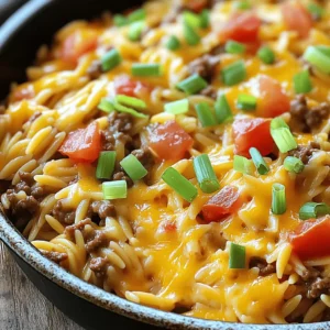 For this dish, you need simple yet flavorful ingredients. Here’s what you will use: - 1 lb ground beef - 1 cup orzo pasta - 1 medium onion, finely diced - 2 cloves garlic, minced - 2 cups beef broth (preferably low-sodium) - 1 cup shredded sharp cheddar cheese - 1 cup canned diced tomatoes with green chilies, drained - 1 tablespoon Worcestershire sauce - 1 teaspoon Italian seasoning - Salt and freshly cracked black pepper to taste - Chopped green onions for garnish These ingredients work together to create a creamy and cheesy meal that feels like a warm hug. Adding garnishes can make your dish pop! Consider these options: - Extra shredded cheddar cheese - Sliced jalapeños for heat - Sour cream for creaminess - Fresh cilantro for a burst of flavor These garnishes can elevate your meal, making each bite even better. You might not have every ingredient on hand. Here are some easy swaps: - Use ground turkey or chicken instead of beef for a lighter option. - Swap orzo for rice or quinoa if you prefer. - Replace beef broth with vegetable broth for a vegetarian dish. - Try different cheeses like mozzarella or pepper jack for unique flavors. These substitutions keep the dish tasty while allowing you to use what you have. This flexibility makes cooking fun and easy! For the full recipe, check out the detailed instructions to create this delicious One-Pot Cheeseburger Orzo Skillet. Start by heating a large skillet over medium heat. Add 1 pound of ground beef and 1 finely diced medium onion. Cook for 5 to 7 minutes. You want the beef to brown and the onion to soften. If there is extra fat, drain it off. Next, add 2 minced garlic cloves to the skillet. Sauté for 1 to 2 minutes. Stir often until the garlic smells nice and turns light golden. This step gives the dish a great base flavor. Now, lower the heat a bit. Stir in 1 cup of orzo pasta, 2 cups of beef broth, and 1 cup of canned diced tomatoes with green chilies (drained). Add 1 tablespoon of Worcestershire sauce and 1 teaspoon of Italian seasoning. Season with salt and pepper to taste. Increase the heat to bring this mix to a lively boil. Once it boils, reduce the heat to low. Cover the skillet and let it simmer for about 10 to 12 minutes. The orzo will become tender, and most of the broth will absorb. Make sure to stir occasionally so the pasta does not stick. After the orzo is cooked, take the skillet off the heat. Gently fold in 1 cup of shredded sharp cheddar cheese. Mix until the cheese melts and makes the dish creamy. Taste your dish and adjust the seasoning if needed. If it needs more salt or pepper, add it now. Serve this cheesy orzo hot. Top with chopped green onions for a fresh look. For the full recipe, check above. To get the best orzo, watch the cooking time. Cook it until tender, but not mushy. Stir often, so it doesn’t stick to the pan. Use low-sodium beef broth to add flavor without too much salt. This broth helps keep the orzo creamy and rich. If you want it al dente, check it a minute early. Remember, it will continue to cook a bit off the heat. Add Worcestershire sauce to give a deep, umami flavor. It makes your dish taste more like a real cheeseburger. You can also toss in fresh herbs like parsley or basil for a fresh twist. A dash of hot sauce or red pepper flakes adds heat if you like spice. For a smoky flavor, consider using smoked cheese or chopped bacon. Each small change ramps up the flavor! One big mistake is not stirring enough. If you don’t stir, the orzo may stick and burn. Another error is using too much broth. This can make your dish too soupy. Taste often to adjust seasoning. If it’s bland, add more salt and pepper. Lastly, don’t skip the cheese! It’s the star of the show and makes the dish creamy and delicious. For the full recipe, check the earlier section. {{image_4}} To make a vegetarian version, swap the ground beef with plant-based meat. You can use lentils or mushrooms for texture. They add a rich, savory taste. Replace beef broth with vegetable broth for a lighter flavor. Add extra veggies like bell peppers, zucchini, or spinach. These will boost nutrition and color. This version still keeps the creamy, cheesy goodness we love. If you love heat, there are many ways to add spice. Consider adding diced jalapeños or crushed red pepper flakes. These will make your dish lively. You can also mix in hot sauce or cayenne pepper. Just a pinch can go a long way. Adjust the heat level to suit your taste. Remember, you can always add more, but you can’t take it out! Cheese lovers can get creative with their choice of cheese. While sharp cheddar is a classic, try pepper jack for a spicy twist. You could also use gouda or mozzarella for a creamy texture. Mixing cheeses adds depth to the flavor. For a fun twist, sprinkle some feta on top before serving. This will give your dish a tangy kick. Enjoy experimenting with different cheese blends! When you have leftover One-Pot Cheeseburger Orzo, store it in an airtight container. Make sure to let it cool down to room temperature first. This helps keep the texture nice and the flavors fresh. You can keep it in the fridge for up to three days. If you want to keep it longer, consider freezing it. To reheat your cheesy orzo, use the microwave or a skillet. If using the microwave, place the orzo in a bowl and cover it with a damp paper towel. Heat it in short intervals, stirring in between until it is hot. If using a skillet, add a splash of beef broth to help rehydrate the dish. Stir over medium heat until warm. If you want to freeze your One-Pot Cheeseburger Orzo, follow these steps: First, let it cool completely. Then, transfer it to a freezer-safe container or bag. Squeeze out as much air as you can to prevent freezer burn. It will last up to three months in the freezer. When you are ready to eat it, thaw it overnight in the fridge and reheat as mentioned above. For the complete recipe, check out the Full Recipe. Yes, you can make this dish ahead of time. Cook it fully and let it cool. Store it in an airtight container in the fridge for up to three days. When you’re ready to eat, reheat it on the stove or in the microwave. Add a splash of broth to keep it creamy. You can easily adjust this recipe. For a gluten-free option, swap the orzo for gluten-free pasta. If you need a dairy-free version, use a dairy-free cheese or skip the cheese altogether. For a healthier option, choose lean ground turkey or plant-based meat. This dish pairs well with a simple green salad or steamed veggies. You can also serve it with garlic bread for a hearty meal. If you want a fun twist, serve it with pickles or chips on the side. For the full recipe, check out the details above! You learned how to make a tasty One-Pot Cheeseburger Orzo Skillet. The recipe is easy and fun. You can customize it with different ingredients or spices. Remember the tips to get the orzo just right and avoid common mistakes. Store leftovers safely, and don’t forget to think about sides to serve. This meal is perfect for any night. Enjoy making it and sharing it with others. Your kitchen will smell amazing!
