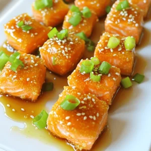 - 1 lb salmon fillet, skin removed and cut into bite-sized cubes - 1/2 cup cornstarch - 1/4 cup honey - 1/2 teaspoon salt - 1/2 teaspoon black pepper - 1/2 teaspoon garlic powder - 2 tablespoons low-sodium soy sauce - 1 tablespoon fresh ginger, grated - 2 garlic cloves, minced - 1 tablespoon sesame oil - 2 green onions, finely chopped - Sesame seeds For the crispy honey garlic salmon bites, you need fresh ingredients. Salmon is the star here, so pick a nice fillet. The cornstarch helps create that crunchy crust we all love. Honey adds sweetness to the dish. The salt, pepper, and garlic powder give the salmon great flavor. The sauce comes together with soy sauce, ginger, and garlic. These ingredients mix to create a tasty coating. Finally, the green onions and sesame seeds make for a pretty finish. You can find the full recipe in the article. Enjoy cooking these bites! - Combine cornstarch, salt, pepper, and garlic powder in a mixing bowl. This mix will give the salmon a nice crunch. - Coat salmon cubes evenly in the cornstarch mixture. Make sure each piece is covered well for that perfect crispy bite. - Whisk honey, soy sauce, ginger, minced garlic, and sesame oil in a separate bowl. This mix adds a sweet and savory flavor. - Set aside for later use. Let the sauce rest while you cook the salmon. - Heat a non-stick skillet over medium-high heat with oil. The oil helps to create a nice golden crust. - Cook coated salmon bites for 2-3 minutes on each side until golden brown. You want them crispy and cooked through. - Transfer to a paper towel-lined plate to absorb excess oil. This keeps them from getting soggy. - Simmer the honey garlic sauce in the skillet until thickened. This makes the sauce rich and sticky. - Toss the cooked salmon bites in the sauce, coating them evenly. Each bite should be full of flavor from the sauce. For the full recipe, check out the details above to get started on these delicious bites! To get that perfect crispy texture, cornstarch is your best friend. Here’s how to use it well: - Coat the salmon cubes evenly in the cornstarch mixture. This helps create a nice crunch when cooked. - Do not overcrowd the skillet. If you add too many salmon bites, they will steam instead of crisp. Cook in batches if needed. Want to kick up the flavor? Here are a couple of easy ways: - Increase the garlic or ginger in the sauce. This makes the dish more aromatic and tasty. - Add a squeeze of lemon juice before serving. It brightens the dish and balances the sweetness of the honey. Making your dish look great is easy with a few tricks: - Arrange the salmon bites neatly on a platter. You can drizzle some leftover sauce over them for extra flair. - Consider adding lemon wedges on the side. They add a pop of color and freshness. Garnishes like chopped green onions or sesame seeds also elevate the look. For the full recipe, check out the recipe section above! {{image_4}} You can easily swap out salmon for other proteins. Shrimp works great, and chicken bites are tasty too. If you choose shrimp, cook them for just 1-2 minutes until they turn opaque. For chicken, make sure to cut it into small pieces and cook for about 4-5 minutes. This way, you get a yummy dish no matter what protein you pick. Want to spice things up? Add some cayenne pepper for a kick. You can also make a teriyaki version. Just switch the honey and soy sauce with teriyaki sauce. This will give you a sweet and savory twist that pairs well with rice or veggies. Don’t hesitate to be creative with your flavors! These salmon bites are perfect as snacks or meals. Pair them with rice or a fresh salad for a full dish. You can also serve them in wraps with greens and sauce for a fun twist. They’re great for parties, so feel free to put them out as appetizers. The crispy texture will impress everyone! You can find the full recipe for these crispy honey garlic salmon bites [here](#). To store leftovers, place the salmon bites in airtight containers. This keeps them fresh and tasty. The recommended shelf life of cooked salmon bites is about 3 days in the fridge. Make sure to let them cool before sealing. If you want to freeze the salmon bites, do it in a single layer on a baking sheet first. This helps keep them from sticking together. After they freeze, transfer them to a freezer-safe bag. They can last about 2 months in the freezer. To reheat, bake them in the oven at 350°F for 10-15 minutes. This helps keep them crispy. You can refresh leftovers in fun ways! Try adding them to salads for a protein boost. You can also use them in tacos with fresh veggies. This makes for a tasty meal. Another idea is to toss them in pasta or rice dishes for added flavor. Enjoy getting creative with your leftovers! For the full recipe, check it out above. Making crispy honey garlic salmon bites is quick and easy. The prep time is just 15 minutes. Cooking takes about 10 minutes, giving you a total time of 25 minutes. This makes it perfect for busy days when you want a tasty meal fast. Yes, you can prepare this dish ahead of time. You can coat the salmon bites and store them in the fridge. Just keep them in an airtight container. They stay fresh for about a day. When you are ready to eat, cook them as directed. This makes meal prep easy and saves time. These salmon bites pair well with many sides. You can serve them with steamed rice or a fresh salad. For drinks, a light white wine or sparkling water works great. You can also try pairing them with a tangy dipping sauce for extra flavor. Absolutely! The salmon bites are great for meal prep. You can make a big batch and store them in the fridge. They stay tasty for up to three days. Reheat them in the skillet for a crispy texture. This makes it easy to enjoy a delicious meal all week. For the full recipe, check the earlier sections. This blog post walked you through making crispy honey garlic salmon bites. You learned about the key ingredients, cooking methods, and tips for perfect texture. Remember to experiment with flavors and proteins or try pairing suggestions for a complete meal. Don’t be afraid to get creative with garnishes for extra appeal. This dish is simple and delicious. You can easily impress friends or family with these bites! Enjoy your cooking journey and make it a fun experience.