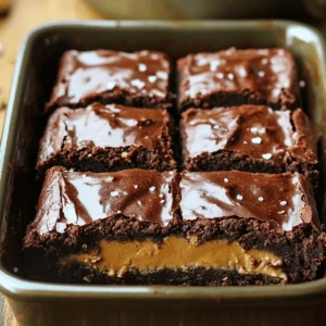 To make Healthy Peanut Butter Stuffed Brownies, gather these items: - 1 cup almond flour - 1/2 cup cocoa powder - 1/2 cup pure maple syrup - 1/3 cup unsweetened applesauce - 1/4 cup coconut oil, melted - 3/4 teaspoon baking soda - 1/2 teaspoon fine sea salt - 1/2 cup natural smooth peanut butter - 1/4 cup dark chocolate chips (optional) - 1/2 teaspoon pure vanilla extract Each ingredient brings its own health perks: - Almond flour is low in carbs and high in healthy fats. - Cocoa powder is rich in antioxidants that help your heart. - Maple syrup adds natural sweetness while being lower on the glycemic index. - Unsweetened applesauce replaces oil and adds moisture without extra sugar. - Coconut oil offers medium-chain triglycerides, which may boost energy. - Peanut butter is packed with protein and healthy fats that keep you full. - Dark chocolate chips bring antioxidants and add a delightful flavor. Accurate measuring ensures your brownies turn out great. - Use dry measuring cups for almond flour and cocoa powder. - Level off the top with a straight edge for precision. - For sticky ingredients like peanut butter, lightly coat the cup with oil first. - Always check the weight for ingredients if you have a kitchen scale. - Follow the amounts in the Full Recipe for best results. Start by preheating your oven to 350°F (175°C). This helps the brownies bake evenly. Next, grab an 8x8 inch baking dish. You can grease it lightly or line it with parchment paper. This way, the brownies will come out easily later. In a large mixing bowl, combine the almond flour, cocoa powder, baking soda, and sea salt. Use a whisk to mix these dry ingredients well. This step is key to making sure there are no lumps in your brownie mix. In another bowl, whisk together the maple syrup, unsweetened applesauce, melted coconut oil, and vanilla extract. Mix until the texture is smooth. This will create a rich, sweet base for your brownies. Now, pour half of the brownie batter into your prepared dish. Spread it evenly across the bottom. Next, spoon dollops of peanut butter over the brownie base. You can spread it gently with the back of a spoon. This adds a creamy layer of flavor. Carefully pour the rest of the brownie batter on top of the peanut butter layer. Smooth it out to cover the peanut butter well. If you want, sprinkle dark chocolate chips on top for extra flavor. Place the baking dish in your preheated oven. Bake for 20-25 minutes. To check if they are done, insert a toothpick into the center. It should come out clean or with a few moist crumbs. Once baked, let the brownies cool in the pan for about 10 minutes. Then, slice them into squares and enjoy! For the full recipe, check the details above. To keep your brownies moist, use applesauce. It adds moisture without extra fat. Measure it out carefully. Almond flour also helps retain moisture. Avoid overbaking; check them early. A toothpick should come out clean or with a few crumbs. One big mistake is overmixing the batter. Mix just until combined. This keeps the brownies soft. Another mistake is not measuring ingredients accurately. Stick to the amounts in the Full Recipe. Also, don’t skip the cooling time. Cutting them too soon leads to a messy slice. You can add a pinch of sea salt on top for a flavor boost. It balances the sweetness. Try mixing in dark chocolate chips for extra richness. You can also swirl in more peanut butter before baking. These touches make your brownies even more delightful! {{image_4}} If you need a gluten-free option, almond flour works great. It keeps the brownies soft and moist. You can also try coconut flour. If you use coconut flour, decrease the amount to about 1/3 cup. This flour absorbs more liquid, so adjust your wet ingredients to keep your brownies rich. To make these brownies vegan, swap the eggs with flax eggs. Mix one tablespoon of ground flaxseed with three tablespoons of water. Let it sit for five minutes until it thickens. Use plant-based milk instead of cow's milk in the recipe. Lastly, ensure your chocolate chips are dairy-free if you choose to add them. While peanut butter is delicious, feel free to experiment. Almond butter adds a different flavor and creaminess. Sunflower seed butter is also a great nut-free alternative. Each nut butter brings unique tastes and textures, making your brownies fun and new every time you bake. For the complete recipe, check the [Full Recipe]. To keep your healthy peanut butter stuffed brownies fresh, store them in an airtight container. This will help prevent them from drying out. Place a piece of parchment paper between layers to avoid sticking. You can keep them at room temperature for up to three days. If you want them to last longer, refrigerate them for up to a week. To maintain the best flavor and texture, avoid exposing the brownies to air. If you plan to enjoy them later, wrap them tightly in plastic wrap before placing them in the container. You can also add a slice of bread to the container. This will help keep the brownies moist and delicious. If you want to store brownies for a longer time, freezing is a great option. First, cut the brownies into squares. Wrap each piece tightly in plastic wrap, then place them in a freezer bag. Label the bag with the date. You can freeze them for up to three months. To enjoy, simply thaw them in the fridge overnight or at room temperature for a few hours. Enjoy the delightful taste whenever you crave a sweet treat! No, almond flour works best here. It adds moisture and a nutty taste. Regular flour can make the brownies dry and less tasty. If you have nut allergies, try a gluten-free blend instead. You can check by inserting a toothpick into the center. If it comes out clean or with a few crumbs, they are done. Baking time can vary, so keep an eye on them after 20 minutes. You can use honey or agave syrup. They will give a sweet taste like maple syrup. Just keep in mind that honey is not vegan, while agave syrup is. Yes, these brownies are great for meal prep! You can make them ahead and store them in the fridge. They last up to a week. Just slice and grab when you want a treat. To make these brownies more chocolatey, add dark chocolate chips. You can also increase the cocoa powder to 3/4 cup. This gives an extra rich flavor that chocolate lovers will enjoy. For the full recipe, check out the details. In this post, we explored key aspects of making brownies. We covered ingredients, health benefits, and measuring tips. I shared step-by-step instructions, from prepping the dish to baking. You learned how to keep brownies moist and avoid common mistakes. We also discussed tasty variations and how to store leftovers. Now, you have the tools to create delicious brownies at home. Enjoy your baking journey!
