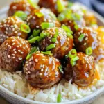 For these tasty meatballs, you'll need: - 1 pound ground beef or ground turkey - 1/2 cup breadcrumbs, whole wheat adds flavor - 1/4 cup grated Parmesan cheese - 1/4 cup fresh parsley, finely chopped - 1 egg, lightly beaten - 2 cloves garlic, finely minced - Salt and freshly cracked pepper, to taste These main ingredients come together to create a rich and satisfying dish. The ground meat serves as the base, while breadcrumbs help bind it. Parmesan cheese adds a nice salty flavor. Fresh parsley gives a fresh touch, and garlic packs a punch. For the sweet and savory sauce, gather: - 1 cup honey, raw adds depth - 1/2 cup low-sodium soy sauce - 1 tablespoon apple cider vinegar - 1 teaspoon ground ginger This sauce is the star of the dish. Honey brings sweetness, while soy sauce adds a salty note. Apple cider vinegar gives a slight tang, and ground ginger adds warmth and spice. Mixing these ingredients creates a sticky glaze that coats the meatballs perfectly. To make your dish pop, consider these garnishes: - 1 tablespoon sesame seeds - 2 green onions, thinly sliced These garnishes enhance the look and flavor of your meal. Sesame seeds add crunch, while green onions provide freshness. They make your dish appealing and flavorful, perfect for serving. Start by grabbing a large mixing bowl. In it, combine 1 pound of ground beef or turkey. Add 1/2 cup of breadcrumbs for texture and flavor. Next, mix in 1/4 cup of grated Parmesan cheese. Then, toss in 1/4 cup of fresh parsley, finely chopped. Don't forget to add 2 minced garlic cloves. This will give your meatballs a great taste. Season with salt and freshly cracked pepper to your liking. Use your hands or a spoon to mix until everything blends well. After mixing, it’s time to shape the meatballs. Take a small amount of the mixture and form it into a ball, about 1 inch wide. Place each meatball on a baking sheet or platter. This keeps them organized and prevents sticking. Aim for uniform sizes to ensure even cooking. It’s a simple step that makes a big difference in your dish. Now for the tasty sauce! In a separate mixing bowl, whisk together 1 cup of honey, 1/2 cup of low-sodium soy sauce, 1 tablespoon of apple cider vinegar, and 1 teaspoon of ground ginger. Mix until it is smooth and well blended. This sauce adds a sweet and savory flavor that makes the meatballs shine. Carefully transfer the formed meatballs into the slow cooker. Once all meatballs are in, pour the honey garlic sauce over them. Make sure each meatball gets coated in that delicious sauce. Secure the lid on the slow cooker. Set it to cook on low for about 6 hours or on high for around 3 hours. You’ll know they’re done when they’re cooked through and tender. After cooking, gently stir the meatballs to coat them in the sauce before serving. To get the best meatball texture, use ground beef or turkey. I like to mix in breadcrumbs for added fluffiness. Whole wheat breadcrumbs add great flavor too. Always add a beaten egg to bind the meatball. This helps them hold their shape while cooking. When mixing, avoid overworking the meat. This keeps the meatballs tender. Form each meatball into a ball about 1 inch wide. This size cooks evenly and stays juicy. When it’s time to serve, I love pairing these meatballs with rice or noodles. The honey garlic sauce adds a sweet touch. For a bright look, sprinkle sesame seeds on top. Thinly sliced green onions also add crunch and color. You can serve them as a main dish or as appetizers. They work well for parties too! Consider adding a fresh side salad for a balanced meal. You can easily prepare these meatballs in advance. Mix the meatball ingredients and form the balls a day before. Place them in the fridge until you’re ready to cook. You can also make the honey garlic sauce ahead of time. Just store it in the fridge. Cooking them in the slow cooker is perfect for meal prep. Let them cook while you do other tasks. This saves time and lets you enjoy a tasty meal later on. {{image_4}} You can use different ground meats for these meatballs. Ground turkey gives a lighter taste. Ground pork adds a nice richness. If you want beef, choose lean ground beef. Each meat brings its own flavor. Just remember to adjust the cooking time if needed. For a gluten-free version, swap breadcrumbs with gluten-free options. Crushed rice crackers work well. You can also use ground oats or almond flour. Check your soy sauce too; use a gluten-free type. These changes keep the dish tasty and safe for those with gluten sensitivities. You can boost flavors in several fun ways. Add chopped bell peppers or onions to the meat mix. Spice it up with a dash of red pepper flakes. For a sweet twist, mix in pineapple chunks. Fresh herbs like cilantro or basil can also brighten the dish. These options let you create your own unique version of honey garlic meatballs. After your meal, let the meatballs cool down. Transfer them to an airtight container. They will stay fresh in the fridge for up to three days. Make sure to keep the sauce with the meatballs for added flavor. If you want to keep them longer, consider freezing. When you’re ready to enjoy the leftovers, there are a few good ways to heat them. You can use the microwave, which is quick and easy. Place the meatballs in a bowl, cover them, and heat for 1 to 2 minutes. Stir halfway for even heating. For the best flavor, try reheating them on the stove. Place meatballs in a skillet with a splash of water or sauce. Heat on low, stirring gently, until warm. This keeps them juicy and tasty. If you want to freeze the meatballs, you can do this easily. Place the cooled meatballs in a single layer on a baking sheet. Freeze them for about an hour until solid. Then, transfer them to a freezer-safe bag. Label the bag with the date and type of meatballs. They will last for up to three months. When ready to eat, thaw them overnight in the fridge. Reheat as mentioned above for a delicious meal. Yes, you can use a different sauce. Try teriyaki or barbecue sauce for a fun twist. Just make sure the sauce has a nice balance of sweet and savory. You want the flavor to shine through. For a spicier kick, add some hot sauce to your choice. This will add depth and excitement to the dish. Cook the meatballs for about 6 hours on low or 3 hours on high. This slow cooking makes the meatballs tender and juicy. Check if they are cooked through by cutting one in half. You want them to be hot all the way inside. This ensures you get the best flavor and texture. Yes, you can bake them in the oven. Preheat your oven to 400°F. Place the meatballs on a baking sheet lined with parchment paper. Bake for 20 to 25 minutes. After that, you can toss them in the honey garlic sauce. This method gives a nice crust while keeping them moist inside. Enjoy experimenting with both methods! You learned how to make tasty honey garlic meatballs. We covered key ingredients and their roles. Next, I shared a simple step-by-step guide. You also saw tips for perfect texture and meal prep. Variations help you customize your dish. Finally, I provided storage and reheating tips. Enjoy experimenting with this recipe and make it your own!