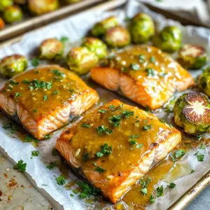 To make the sheet-pan honey mustard salmon and sprouts, you will need the following ingredients: - 4 skinless salmon fillets - 2 cups Brussels sprouts, trimmed and halved - 3 tablespoons Dijon mustard - 2 tablespoons honey - 2 tablespoons extra-virgin olive oil - 2 cloves garlic, finely minced - Salt and freshly ground black pepper, to taste - 1 teaspoon smoked paprika - Fresh parsley, finely chopped (for garnish) Each ingredient plays an important role. The salmon gives a rich taste. The Brussels sprouts add a nice crunch. The honey and mustard make a sweet and tangy sauce. Olive oil keeps everything moist. Garlic, salt, pepper, and smoked paprika add depth. Finally, parsley makes the dish look fresh and bright. Gather your ingredients before you start cooking. This way, you will have everything ready and can enjoy the cooking process. Each step gets easier when you have what you need at hand. - Preheat the oven to 400°F (200°C). - Prepare a large sheet pan by lining it with parchment paper. - In a bowl, mix Dijon mustard, honey, olive oil, minced garlic, smoked paprika, salt, and pepper. Whisk until smooth. - Place salmon fillets on one side of the sheet pan. Coat them with half of the honey mustard mix. - On the other side, arrange halved Brussels sprouts in a single layer. Drizzle the rest of the honey mustard mix over them. Toss gently to coat. - Place the sheet pan in the oven and bake for 15-20 minutes. The salmon should flake easily when done, and the Brussels sprouts should be tender with a slight char. After baking, let the pan cool a bit to avoid burns. To achieve perfect doneness, aim for an internal temperature of 145°F (63°C). This ensures the salmon is safe to eat and retains its moisture. Use a meat thermometer for the best results. For optional seasoning enhancements, try adding lemon zest or fresh dill to the honey mustard sauce. Both options brighten the dish and add depth to the flavor. To get that perfect char on your Brussels sprouts, spread them in a single layer on the pan. Avoid crowding them so they roast evenly. For additional flavoring ideas, toss the sprouts with balsamic vinegar or add crumbled bacon before baking. Both will elevate the taste and add an exciting twist. {{image_4}} If you want to switch things up, consider these options: - Alternative fish options: You can use trout or cod instead of salmon. Both fish have a mild flavor and cook well. They also absorb the honey mustard sauce nicely. - Different vegetables to include: Instead of Brussels sprouts, try green beans or asparagus. Zucchini and bell peppers work too. Cut them into similar sizes so they cook evenly. Changing the flavor can make this dish unique: - Modifying the honey mustard sauce: You can add a bit of soy sauce for a salty kick. If you like heat, mix in some Sriracha or crushed red pepper. This will give the sauce a nice zing. - Adding herbs or spices: Fresh dill or thyme can brighten up the dish. A sprinkle of cayenne can add warmth. You could also use lemon zest to give it a fresh twist. To store leftovers, let the salmon and Brussels sprouts cool first. Place them in an airtight container. This keeps the food fresh and tasty. You can store them in the fridge for up to three days. If you want to keep them longer, freeze them for later use. For reheating, the oven works best. Preheat it to 350°F (175°C). Place the salmon and sprouts on a baking sheet. Heat for about 10-15 minutes. This method keeps the flavor and texture great. You can also use a microwave if you are in a hurry. Just be careful not to overheat. Enjoy your meal as if it was fresh! Can I use frozen salmon? Yes, you can use frozen salmon. Just thaw it first. This helps the fish cook evenly. You can thaw it in the fridge overnight or use the microwave for a quick option. How long will leftovers last? Leftovers will stay fresh for up to three days in the fridge. Store them in an airtight container. This keeps the flavors locked in and prevents spoilage. Can I cook this dish in an air fryer? Absolutely! You can use an air fryer for this recipe. Cook at 375°F for about 12-15 minutes. Check for doneness to ensure the salmon is flaky and the sprouts are tender. Health benefits of salmon and Brussels sprouts Salmon is rich in omega-3 fatty acids. These fats support heart health and brain function. Brussels sprouts are high in vitamins C and K. They also contain fiber, which aids digestion. Caloric breakdown per serving Each serving has about 350 calories. This includes the salmon, Brussels sprouts, and sauce. It’s a balanced meal that provides protein and nutrients without excess calories. This recipe shows how to make a tasty dish with salmon and Brussels sprouts. You learned about the key ingredients, like skinless salmon fillets and honey mustard sauce. I walked you through the steps, from prep to cooking. I shared tips for perfect salmon and flavorful Brussels sprouts. You can even try ingredient swaps for new tastes. Remember to store your leftovers properly to enjoy later. Now, you have everything you need to make this meal a hit! Enjoy your cooking adventure!